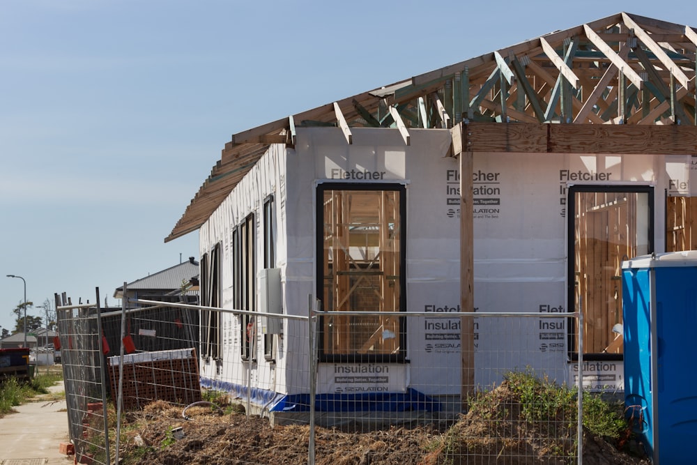 a house under construction with a fence around it