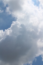 A dynamic illustration of data flowing smoothly into cloud servers under a bright sky.