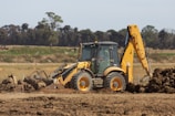 a bulldozer digging dirt in a field