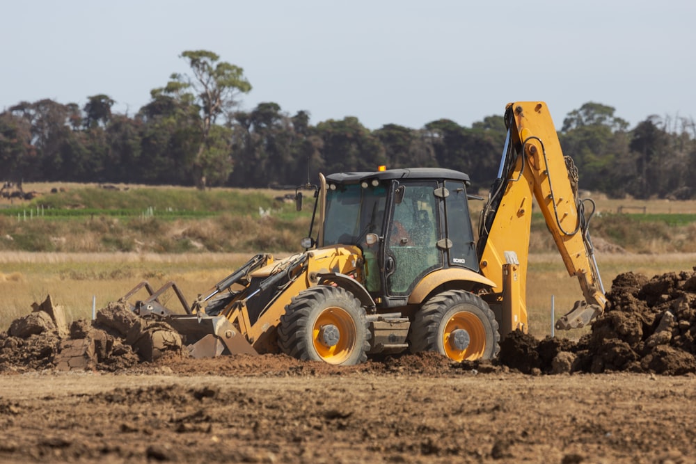 a bulldozer digging dirt in a field