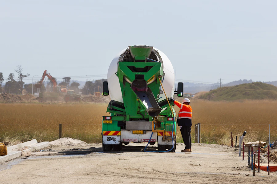 A concrete mixer truck arriving at a job site.