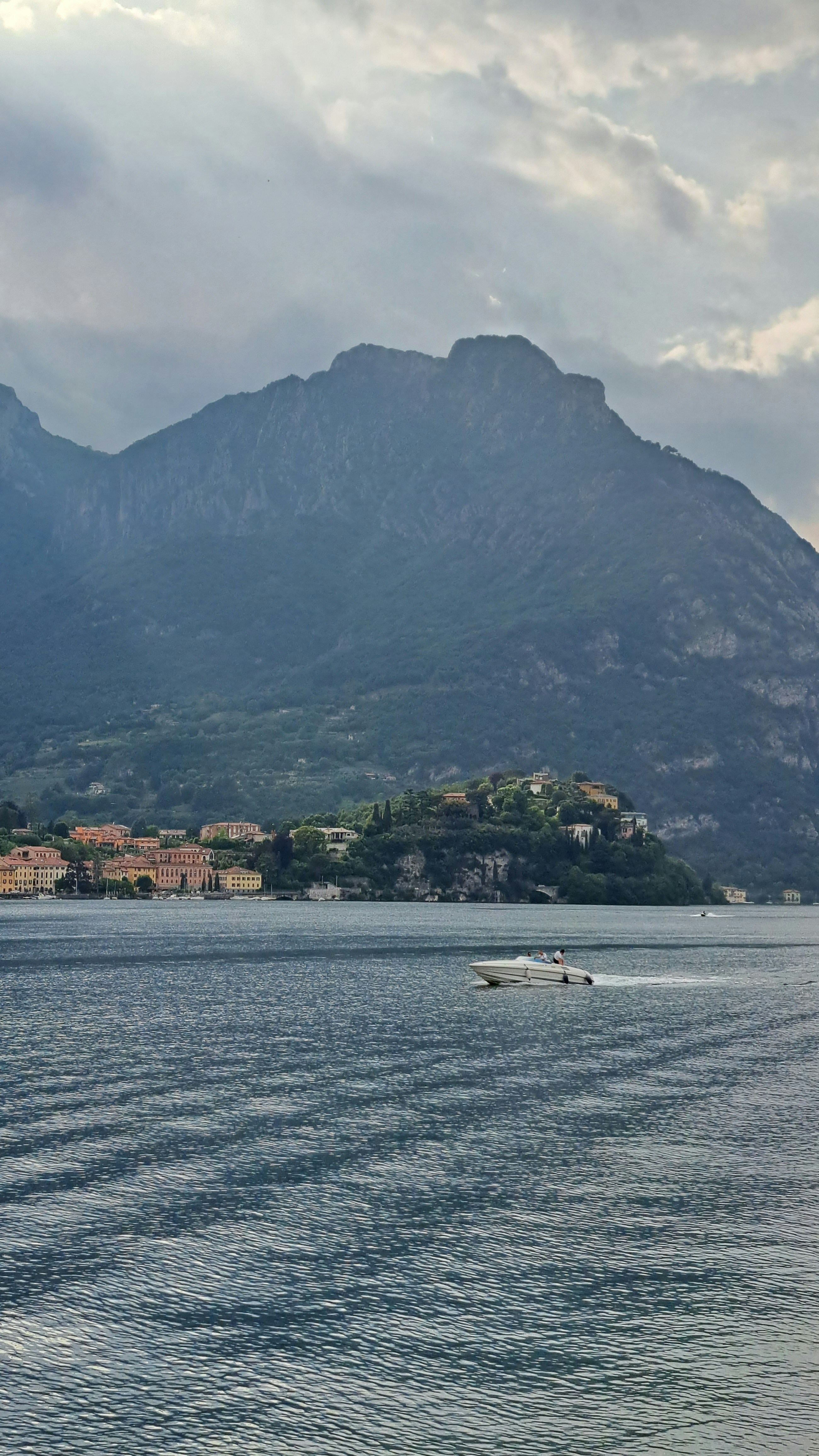 a boat in a body of water with mountains in the background