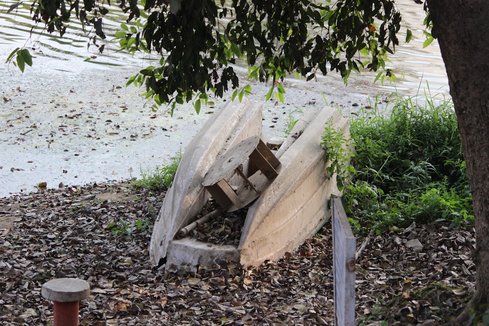 a wooden boat sitting on top of a pile of rubble