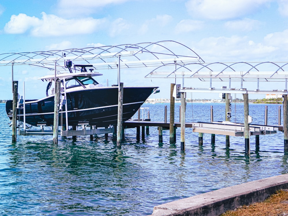 a boat is docked at a pier on the water