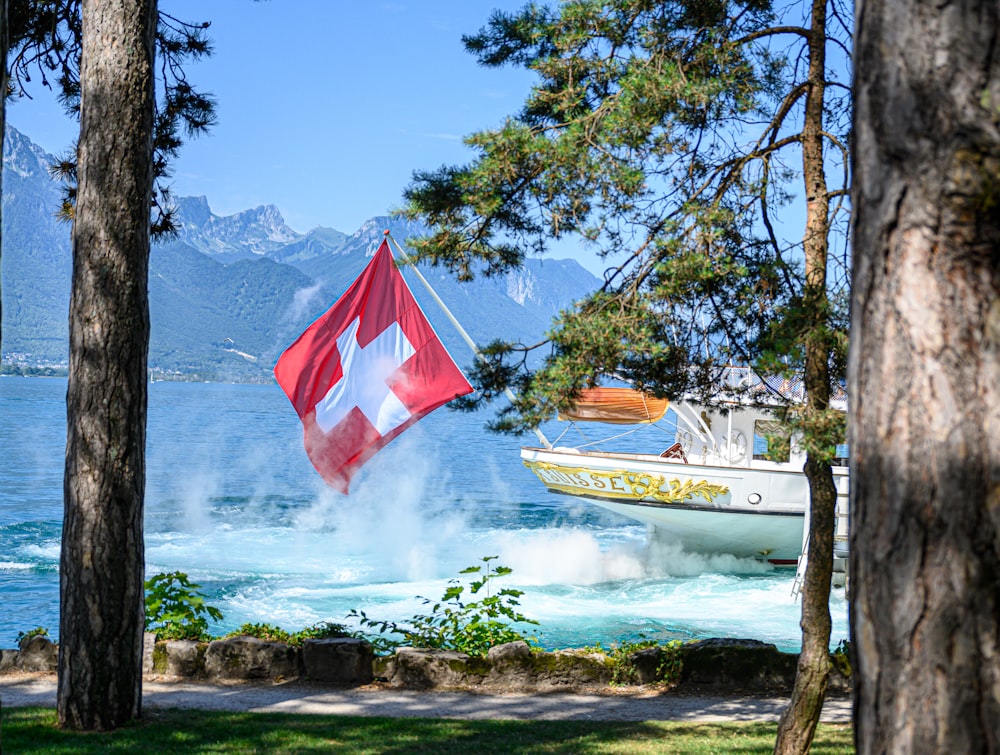 a boat in the water with a flag flying from it