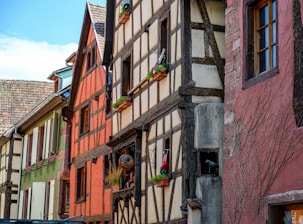 a row of old buildings with windows and shutters