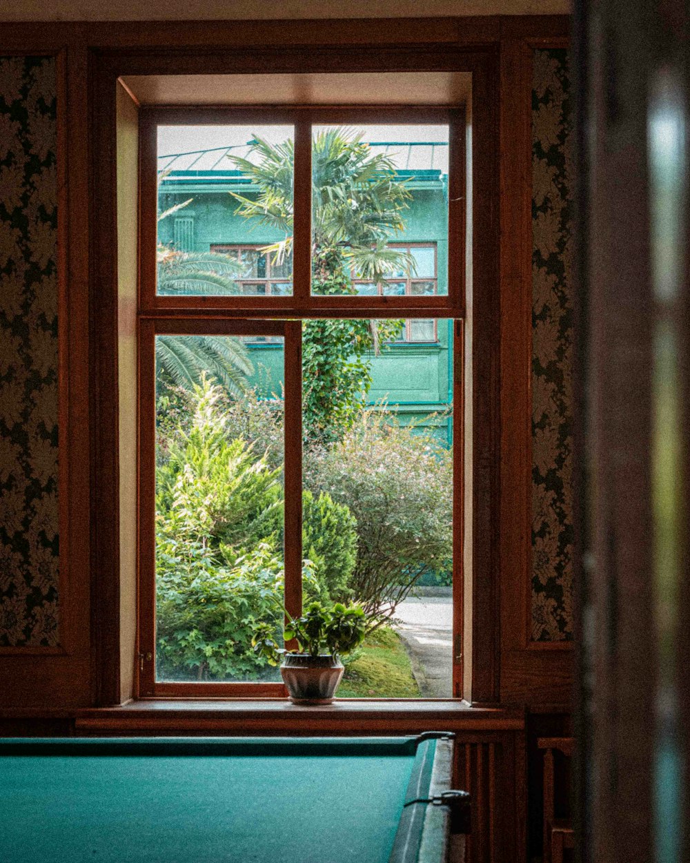 a pool table sitting in front of a window