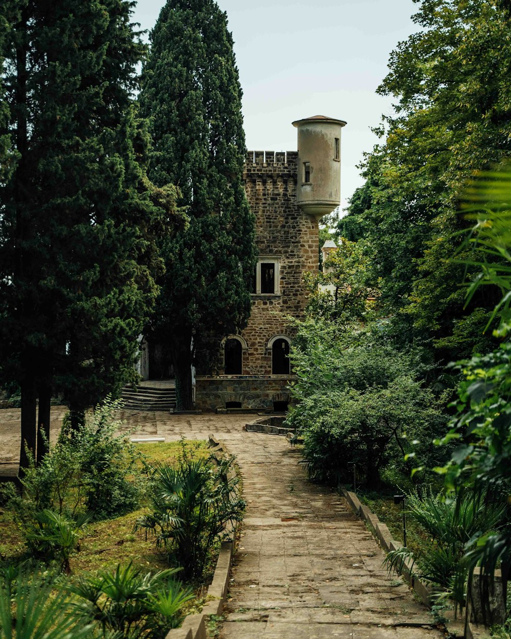 a stone path leading to a tall tower