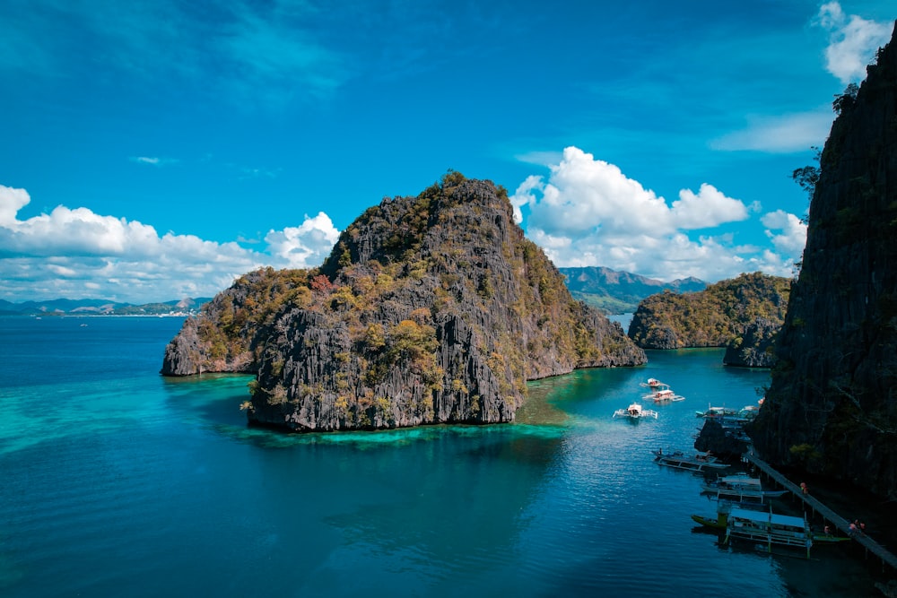 a group of boats floating on top of a body of water