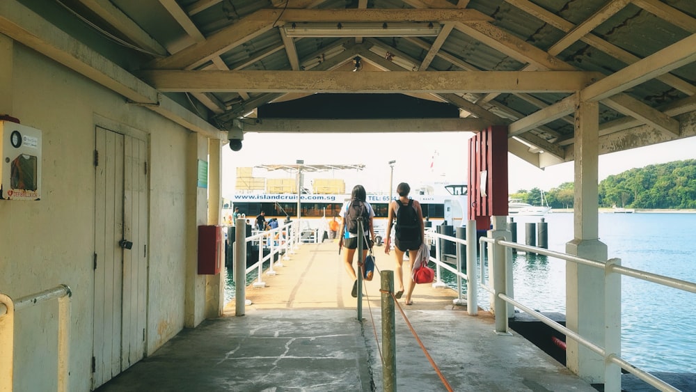 a couple of people that are standing on a dock