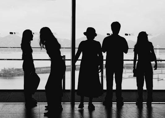 a group of people standing in front of a window