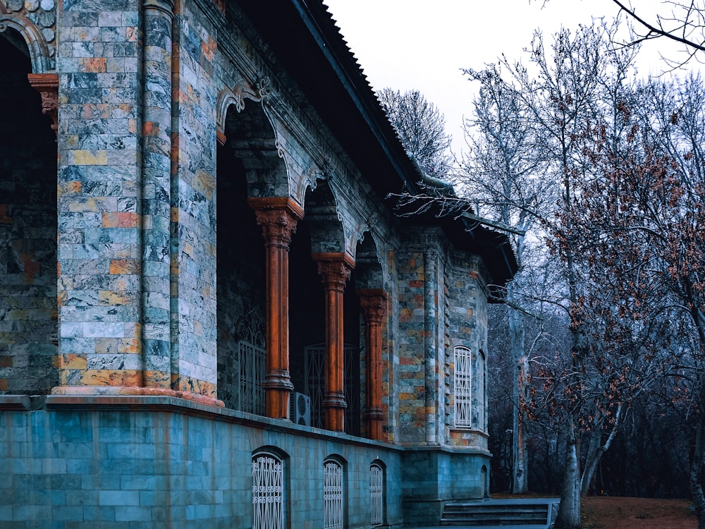 a stone building with a clock on the front of it