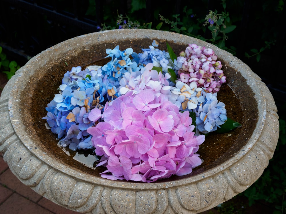 a planter filled with lots of purple and blue flowers