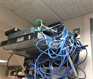 Networking equipment arranged on a shelf.