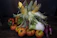 Close-up of fresh vegetables arranged on a rustic wooden table at a local farm.
