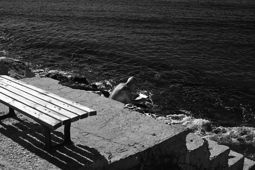 a wooden bench sitting on top of a rocky beach