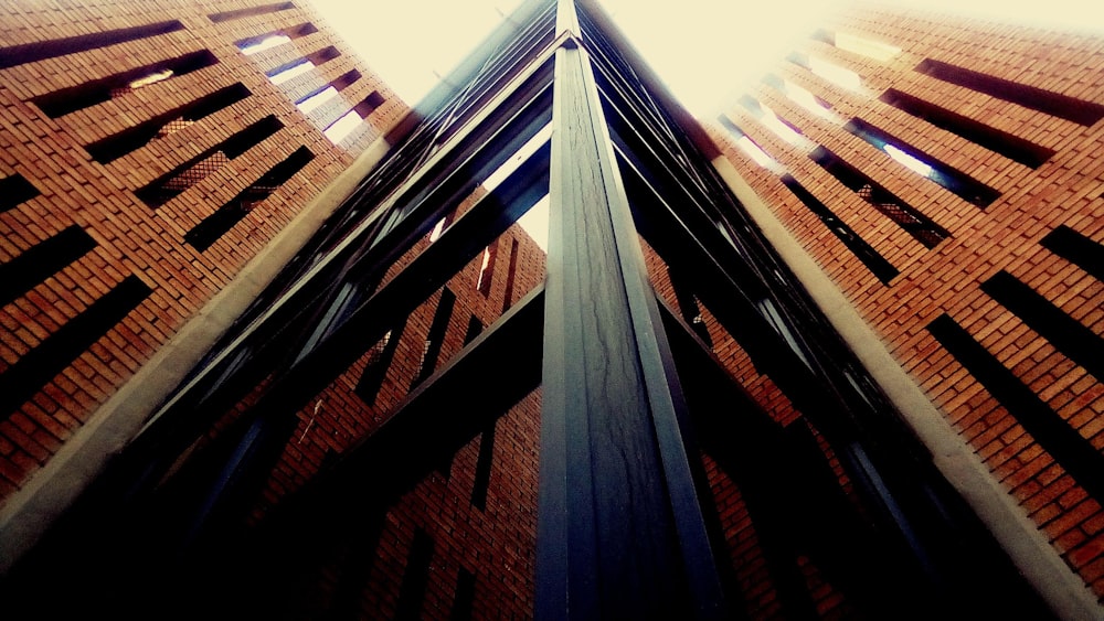 a tall brick building with a clock on it's side