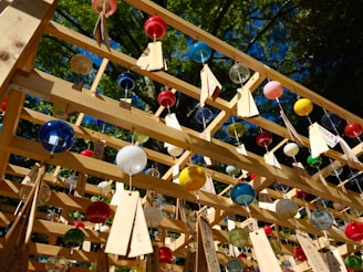 Colorful decorative garden wind chimes gently swaying in a soft breeze.