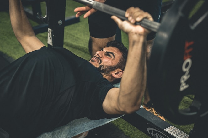 a man doing a bench press with a barbell