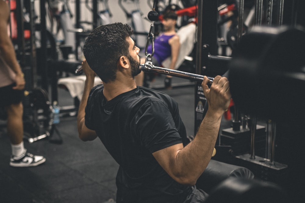 a man in a gym lifting a bar