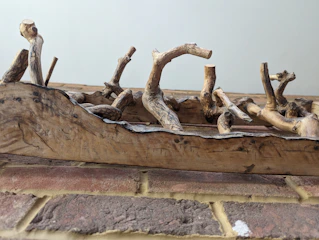 Artistic piece showing natural wood intertwined with industrial materials.