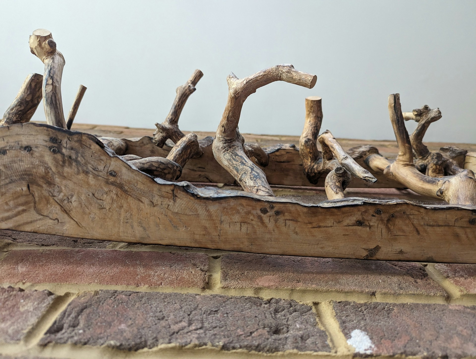 An artistic sculptural furniture piece blending form and function with expressive wooden elements.