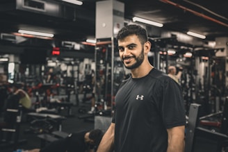 A smiling trainer guiding a client through a workout in a bright Las Vegas gym