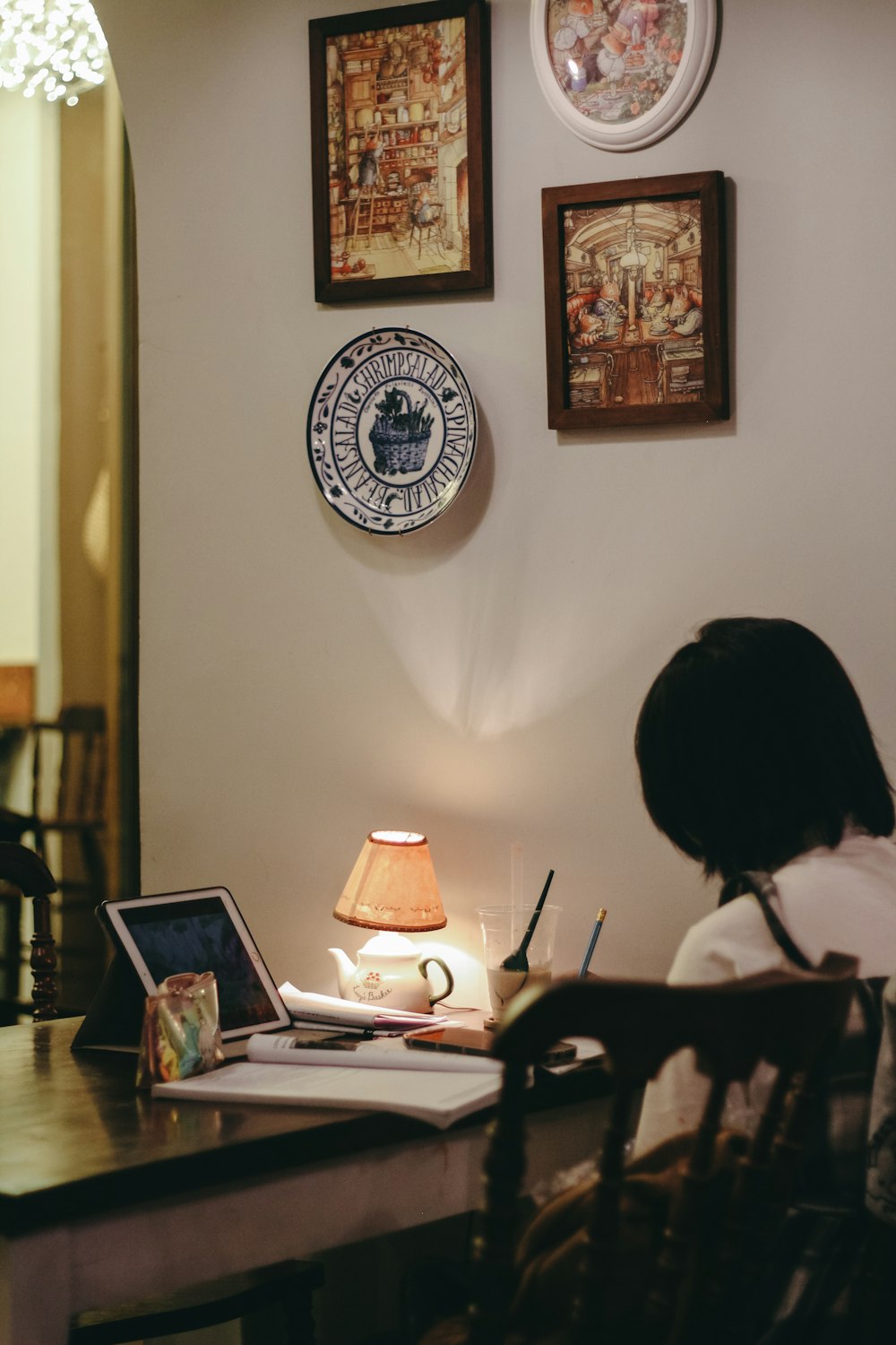 a person sitting at a desk with a laptop