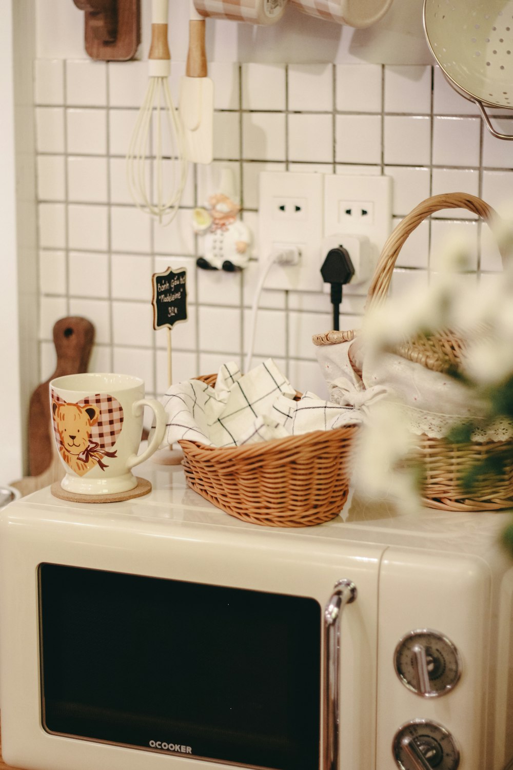 a microwave with a basket on top of it