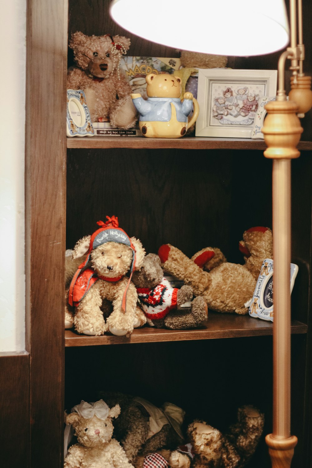 a book shelf filled with lots of stuffed animals