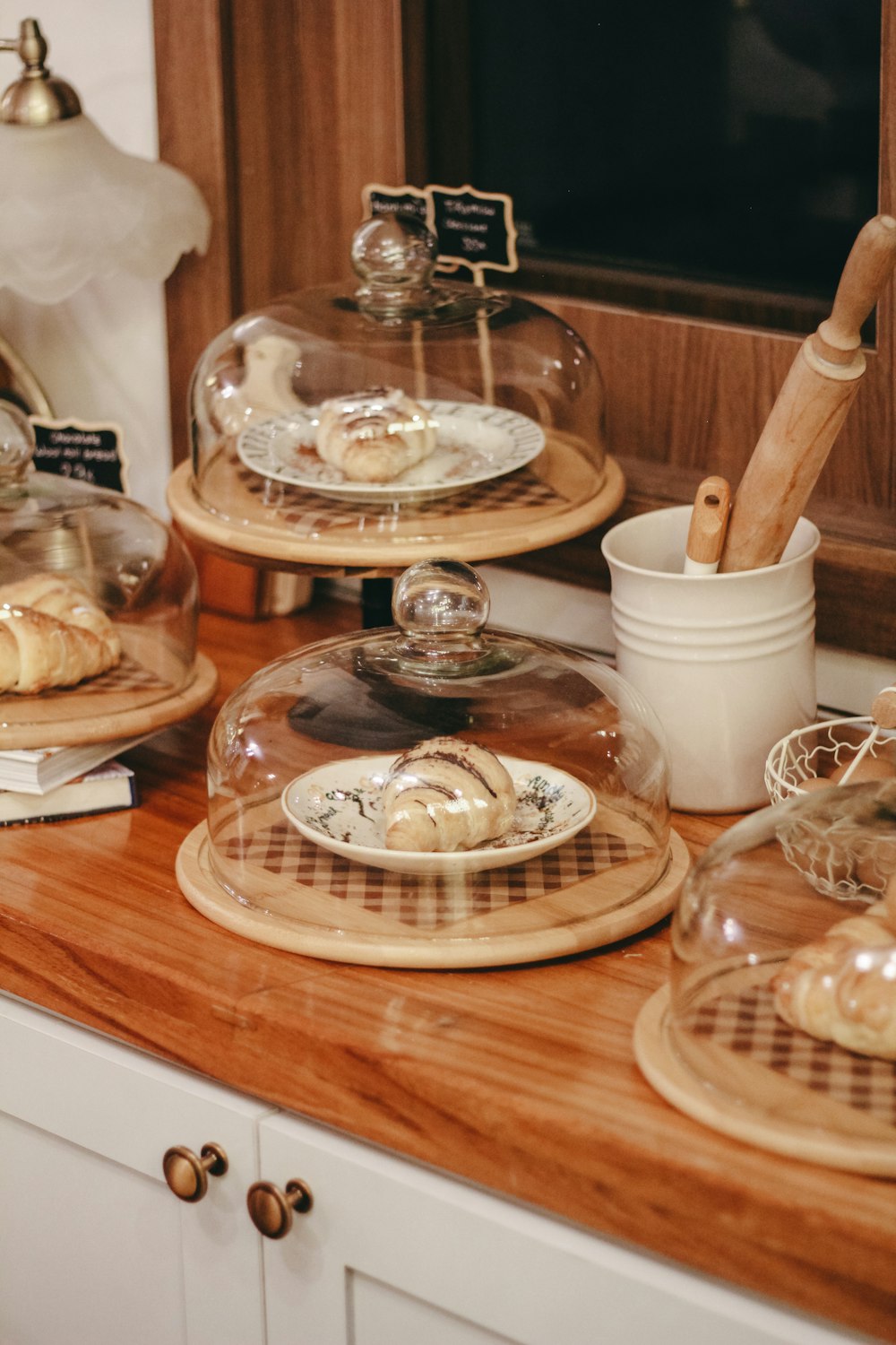a wooden counter topped with plates and bowls filled with food