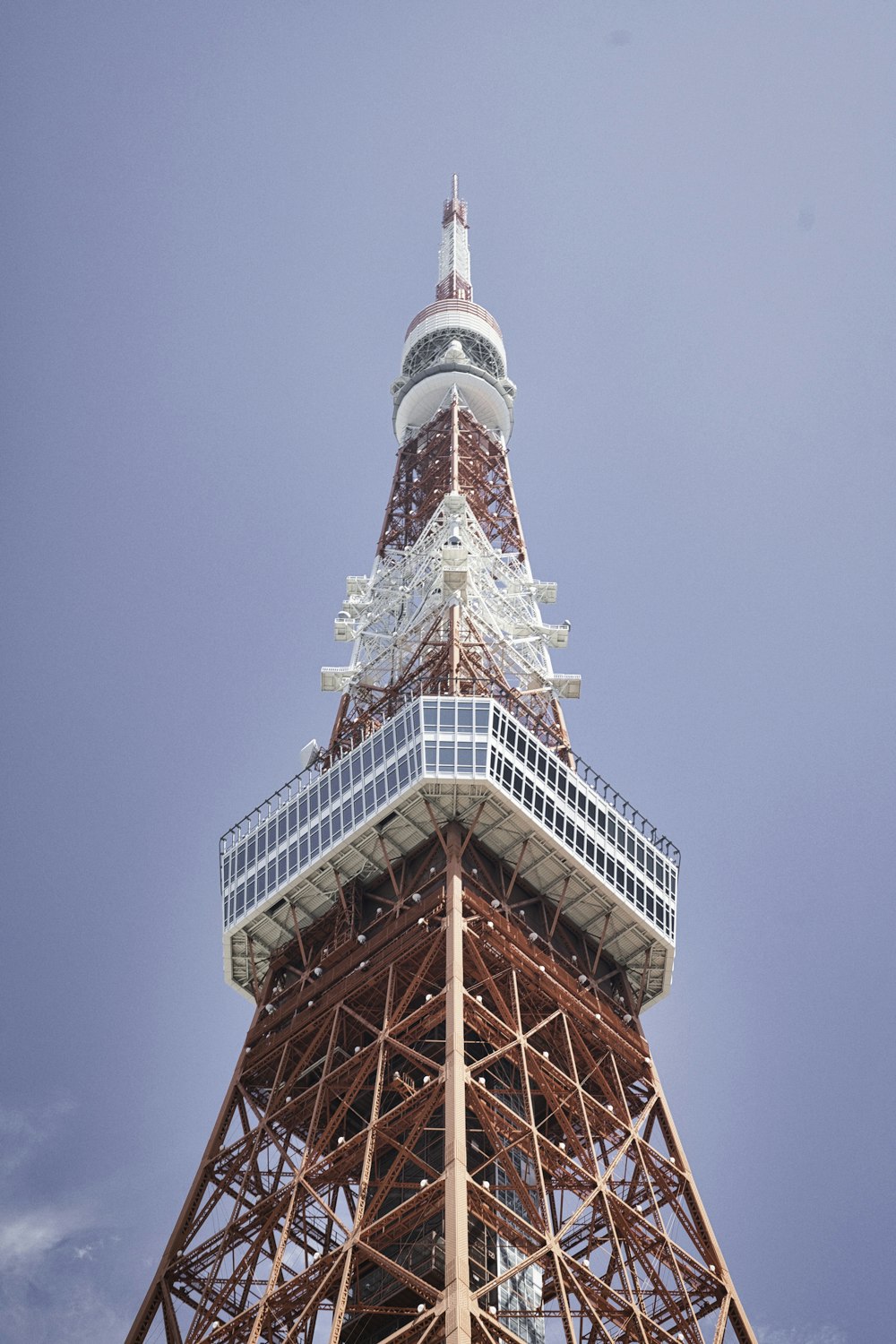 the top of the eiffel tower against a blue sky