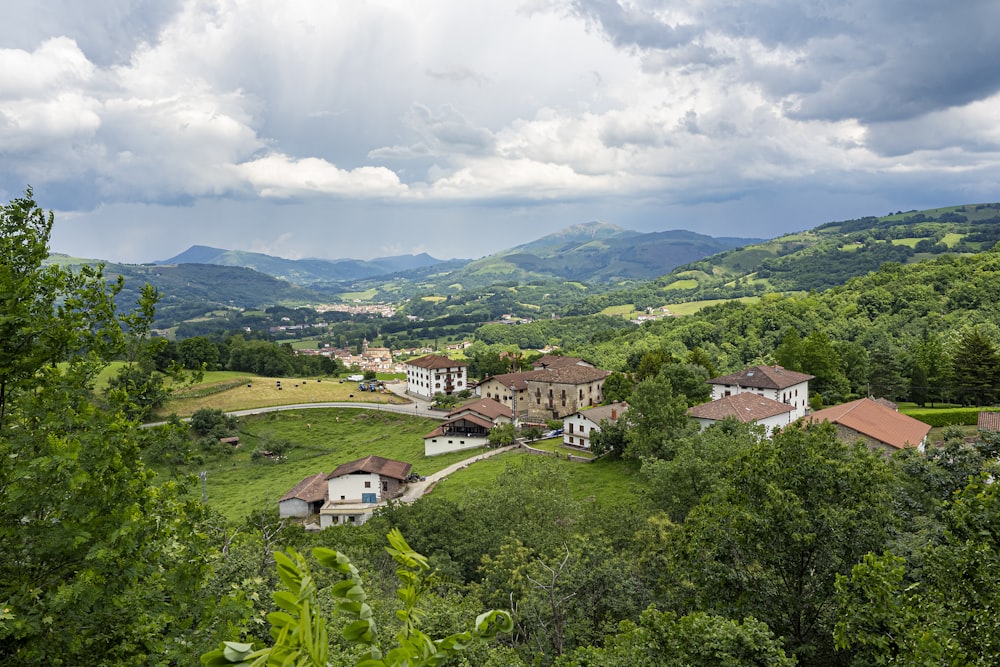 a scenic view of a village in the mountains
