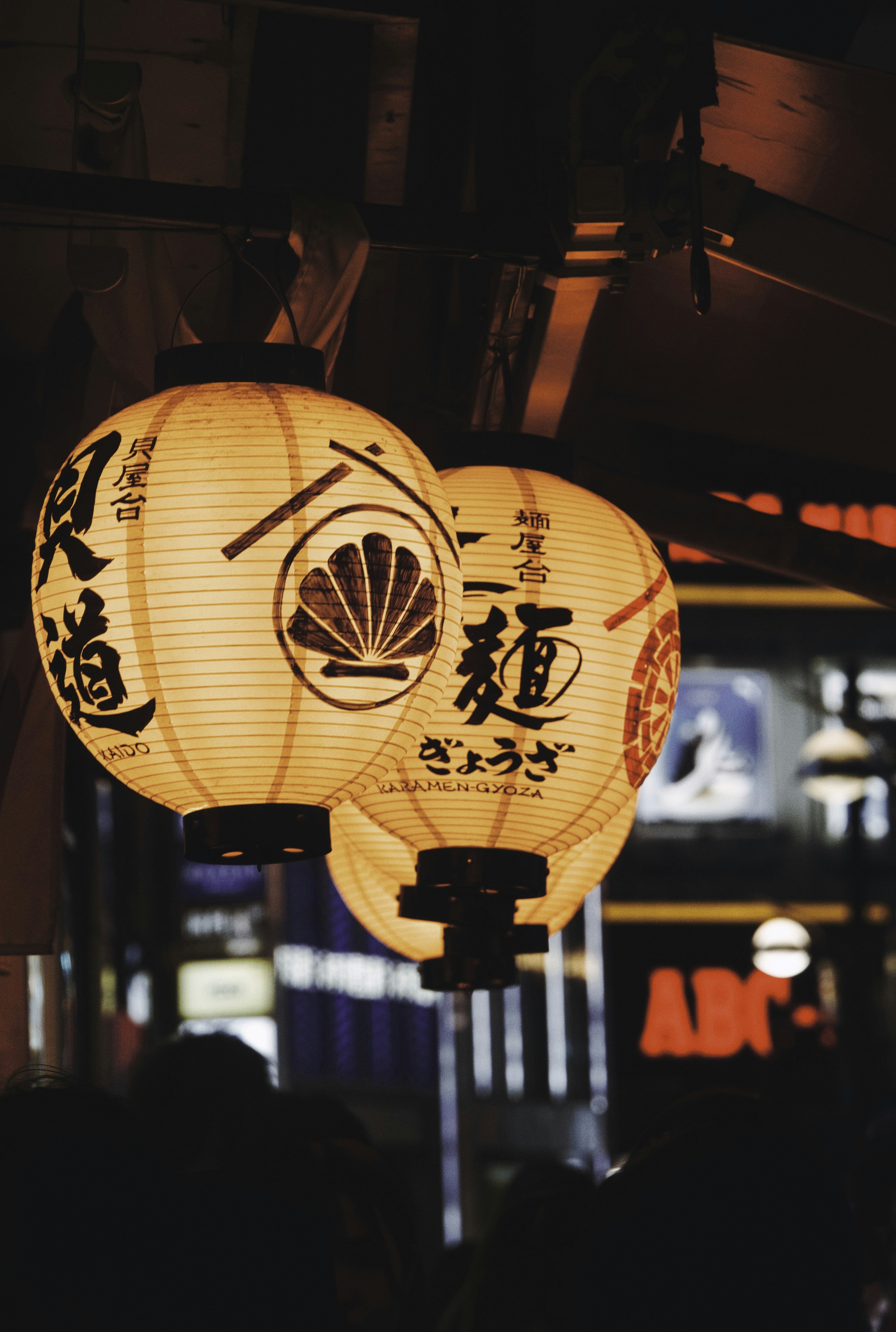 a couple of paper lanterns hanging from a ceiling