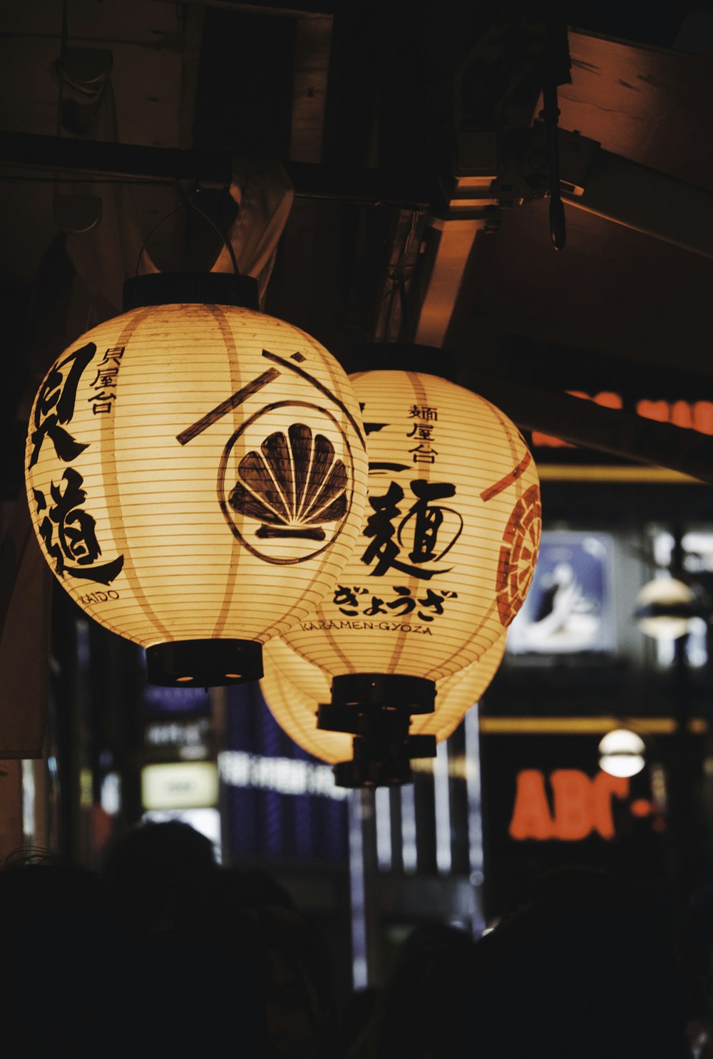 a couple of paper lanterns hanging from a ceiling
