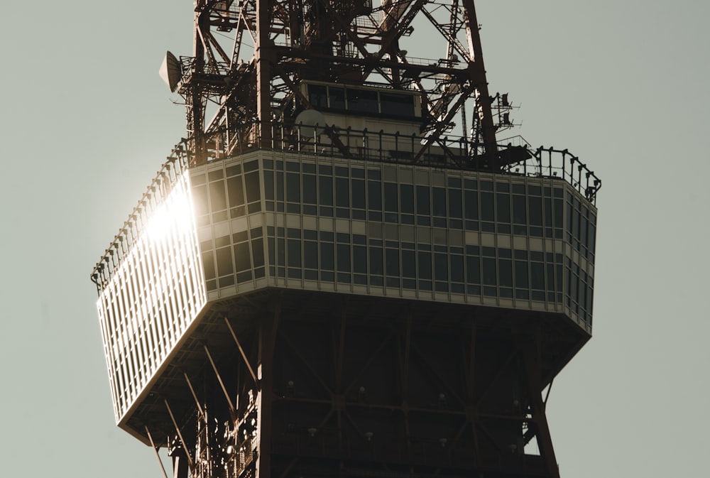 the top of a tall tower with a sky background