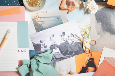 A collage of fashion sketches, magazine cutouts, and colorful stickers on a scrapbook page.