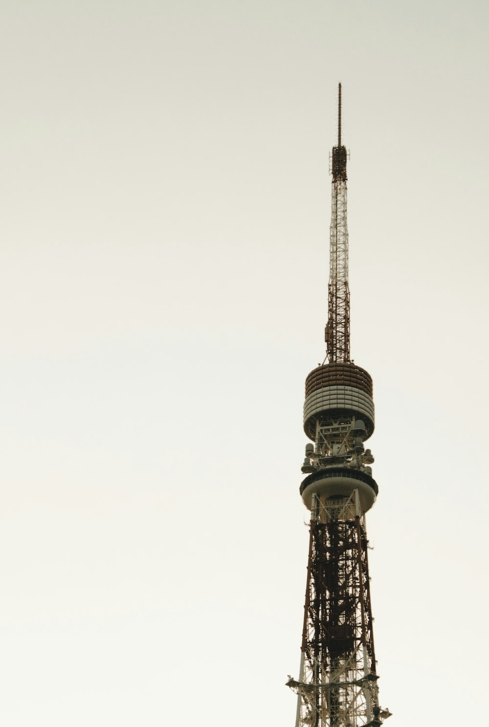 a very tall tower with a very tall clock on it's side