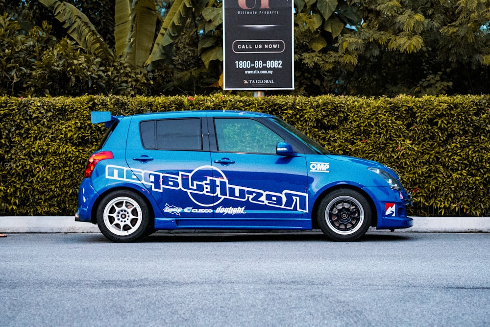 a blue minivan parked on the side of the road