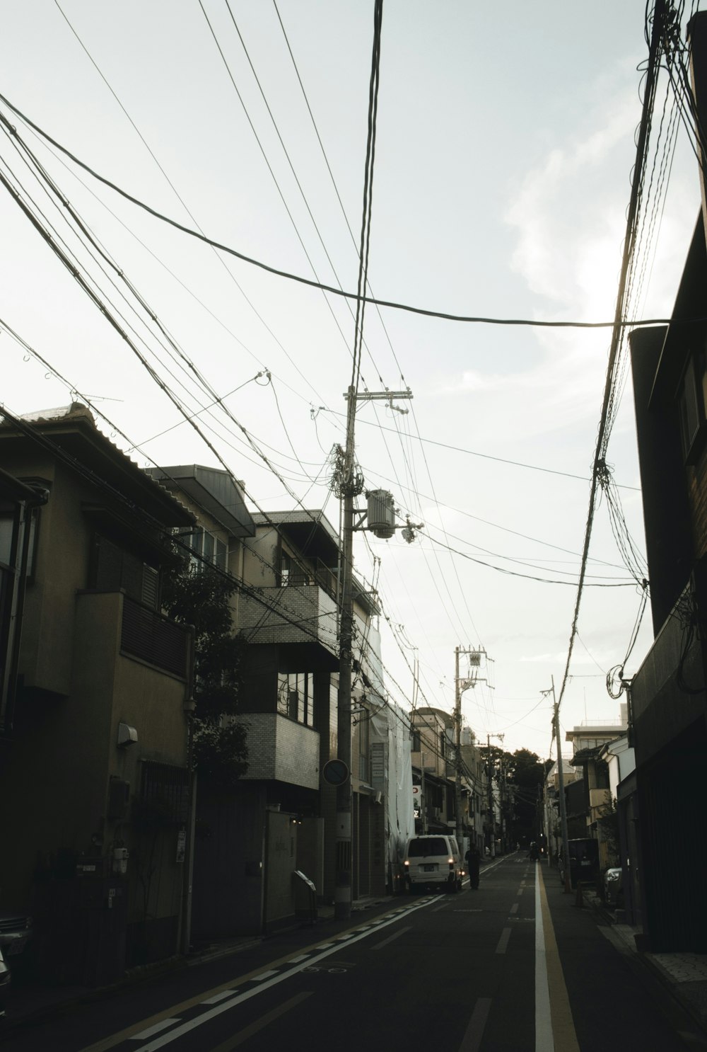 a city street lined with tall buildings and power lines