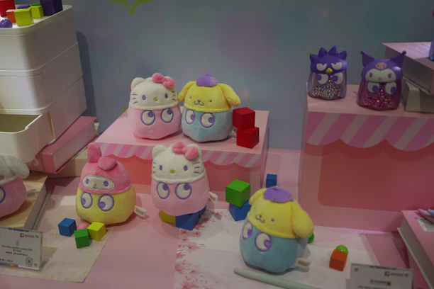 A colorful display of educational toys and cute girls' clothing on racks.