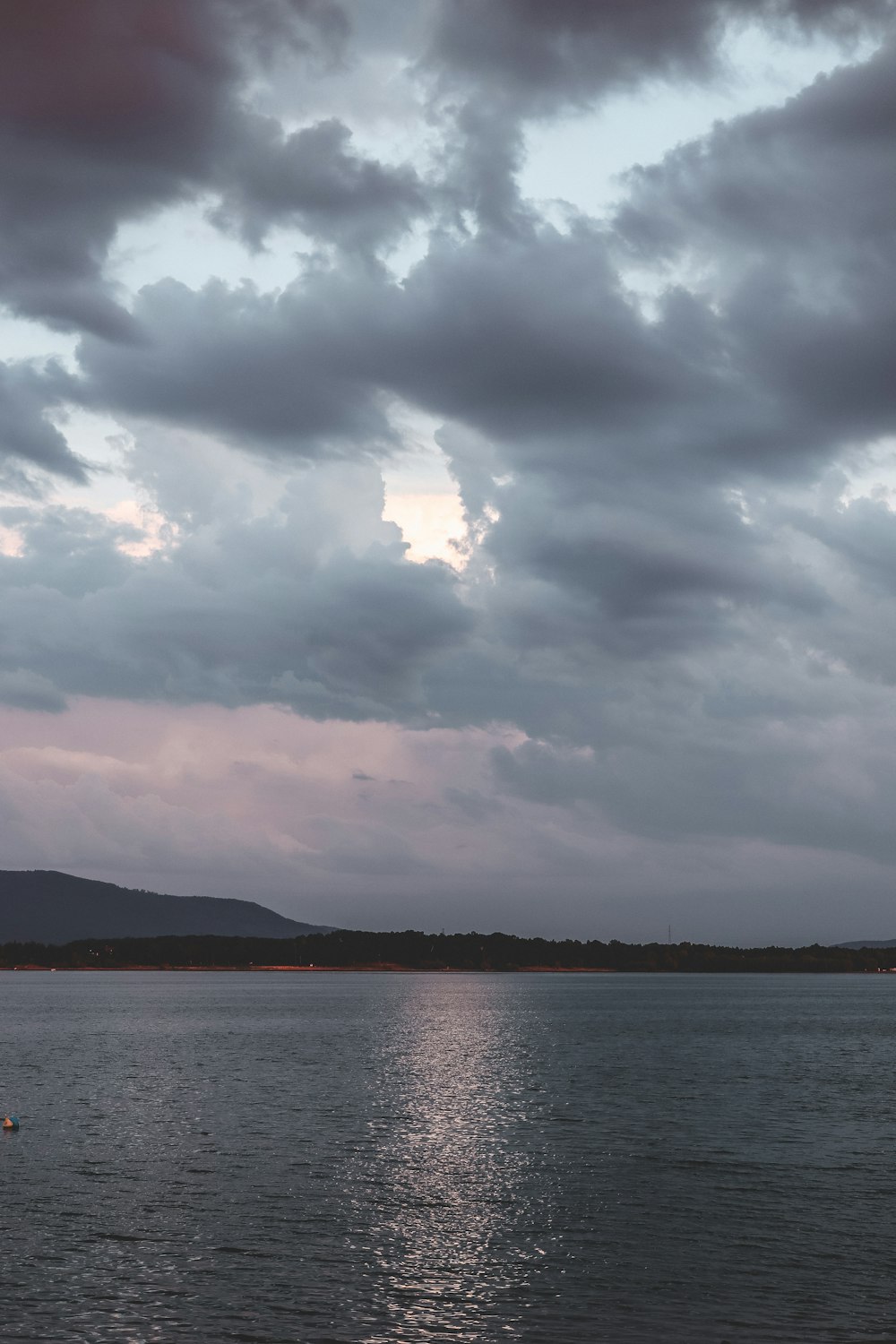 a large body of water under a cloudy sky