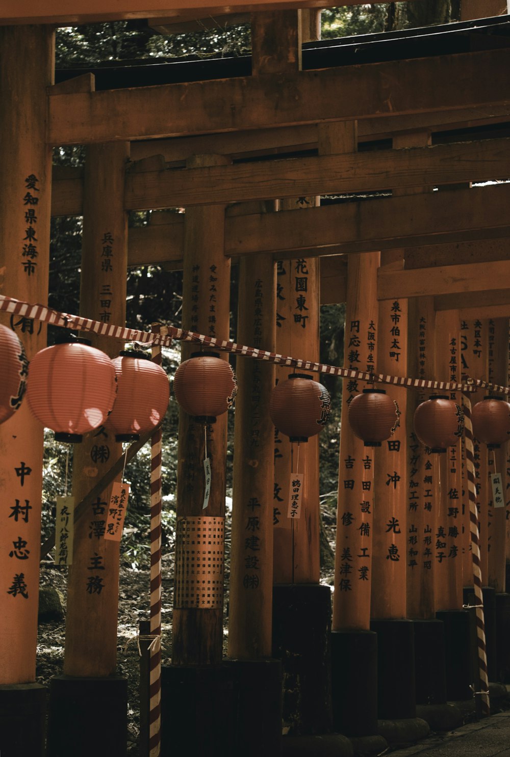 a group of wooden pillars with asian writing on them