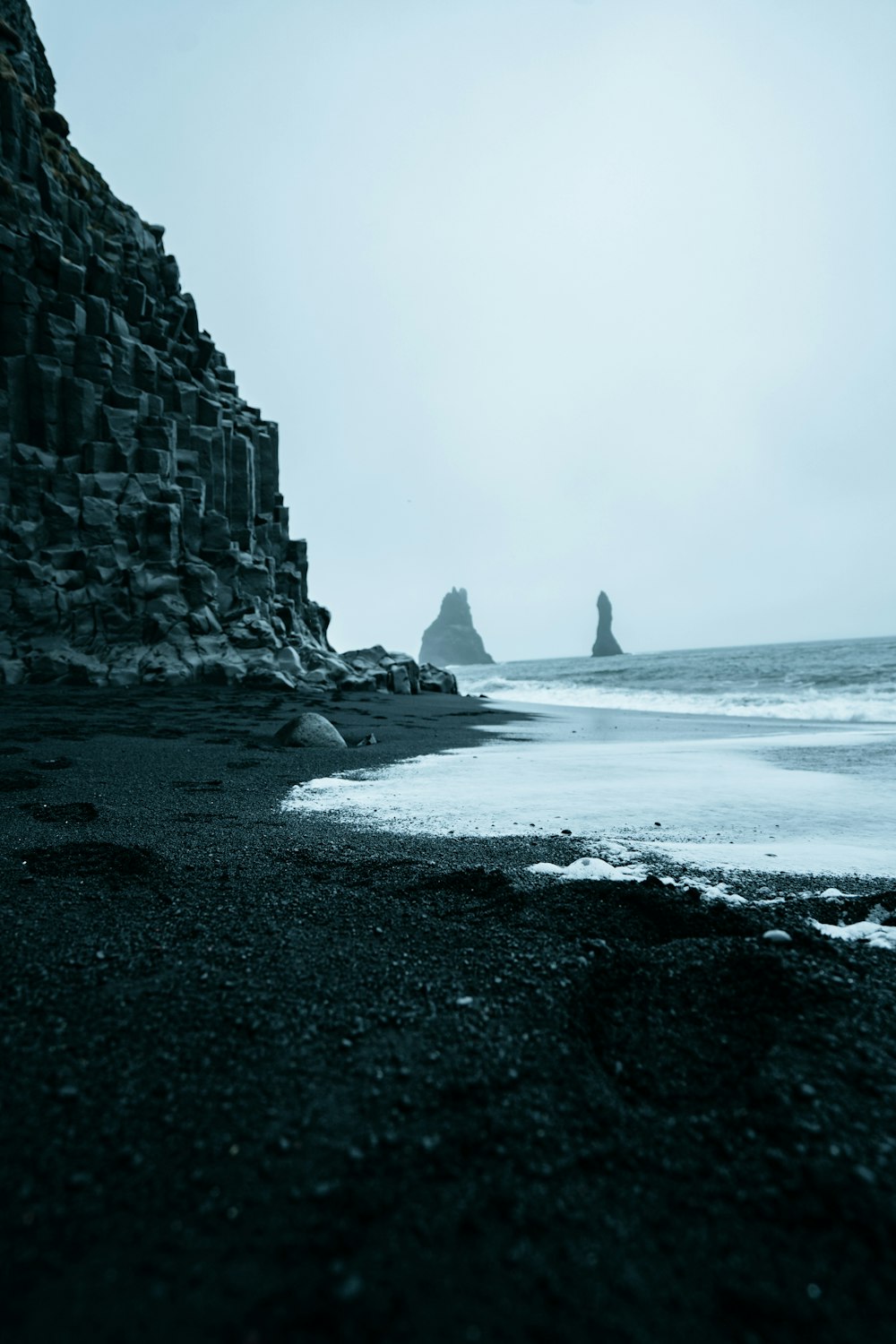 a rocky beach next to a large body of water