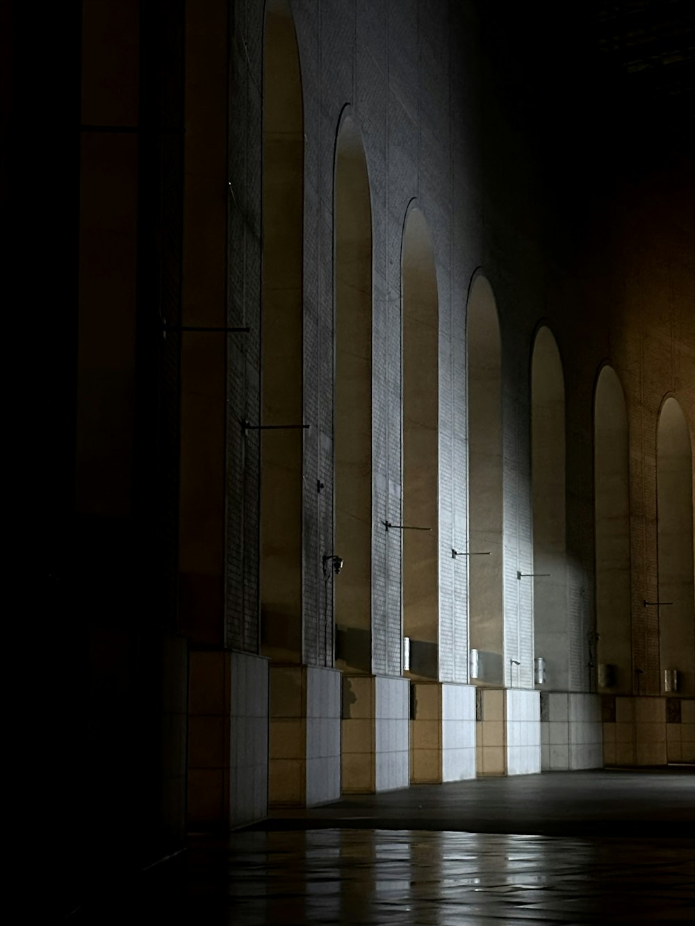 a dark room with a row of arches