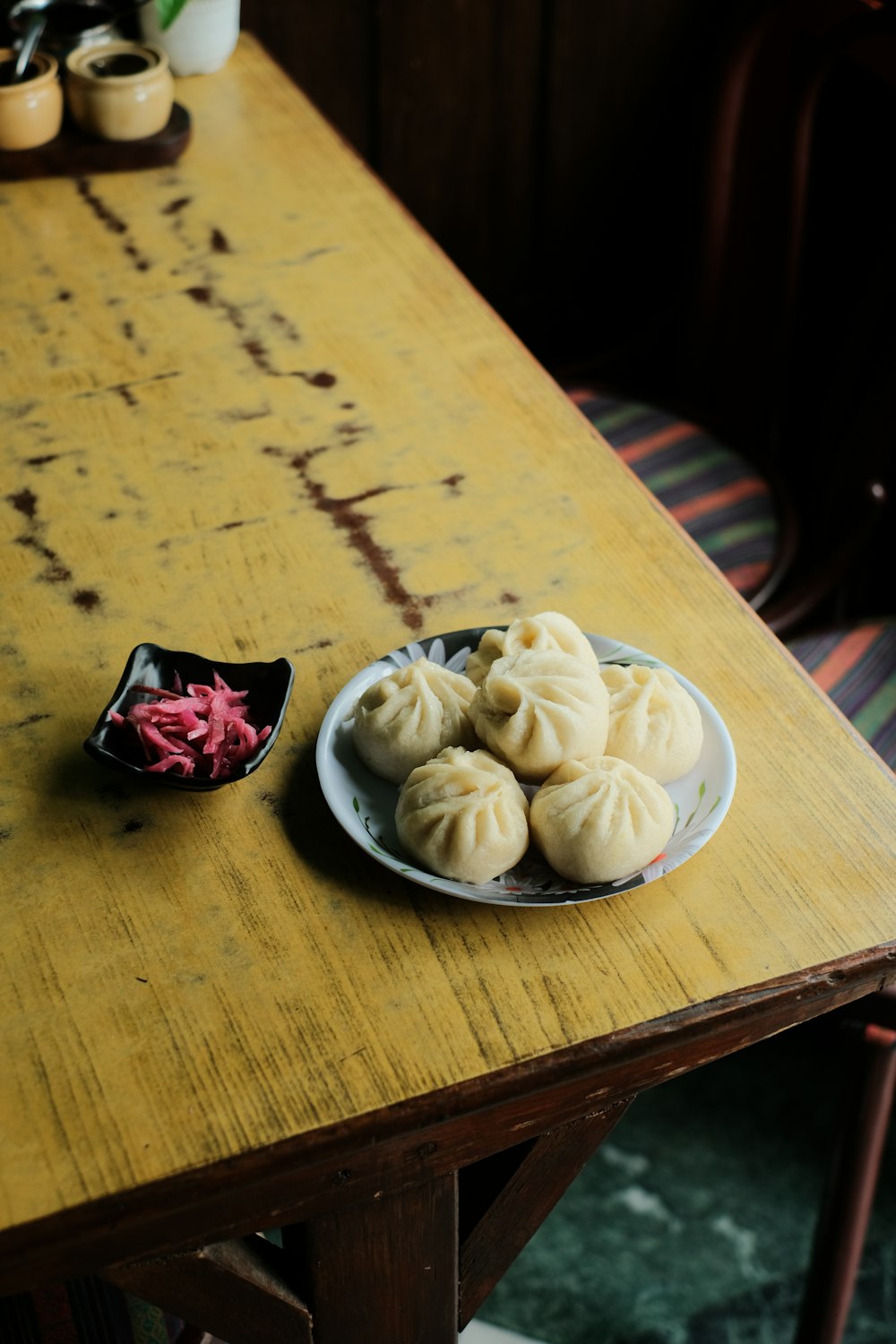 a plate of dumplings on a wooden table