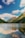 A serene mountain landscape with a tranquil lake reflecting the sky.