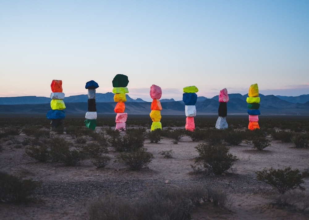 a number of different colored pieces of paper in the desert