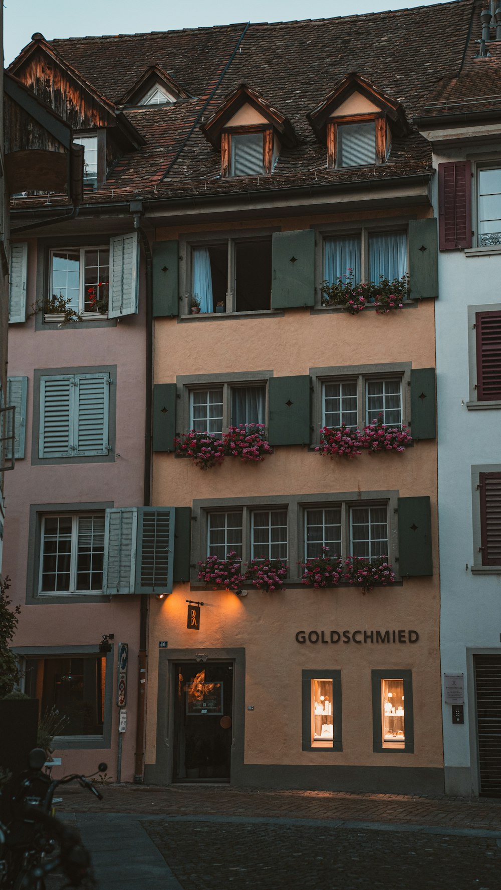 a tall building with many windows and shutters