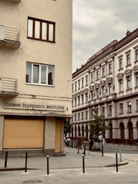 A vibrant street scene in Kyiv with colorful buildings and people using smartphones.
